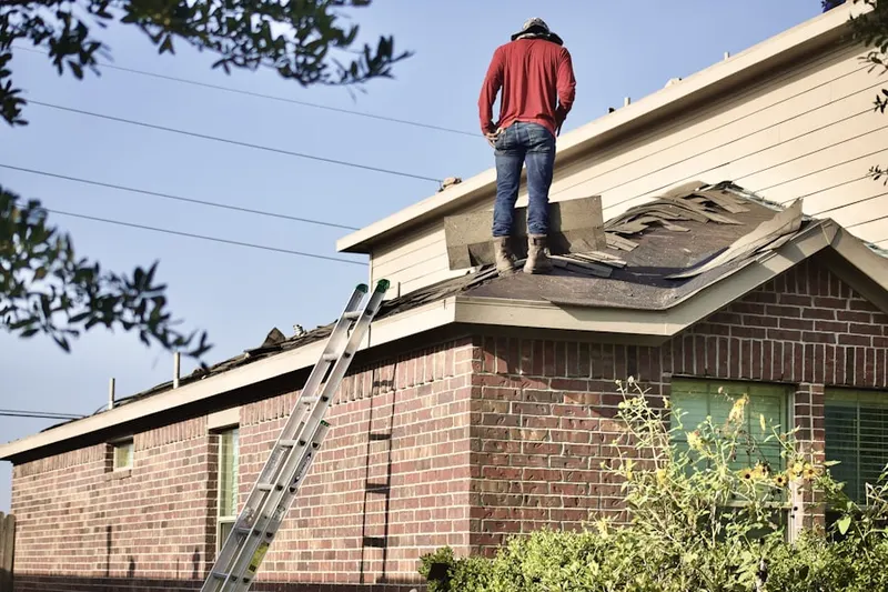 Professional roofer working on a residential roof in Britigans Sunset Ridge